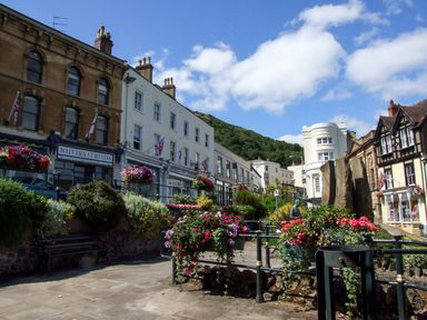 A street with flower beds and mixed architecture buildings in Malvern