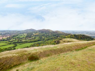 A rural landscape with hills trees and fields at Garden View in Malvern