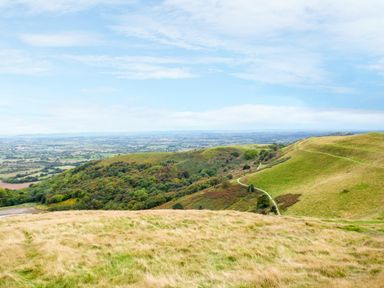 A landscape of grassy hills and a winding path with fields in the background at Garden View in Malvern