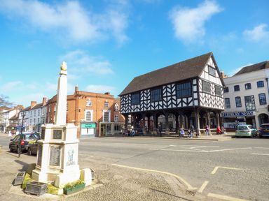 A street view with a monument and a black and white timber building surrounded by other buildings at Garden View in Malvern