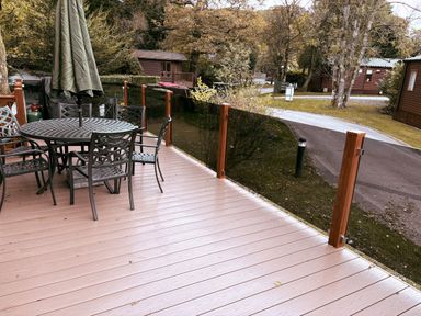 An outdoor dining area with a table and chairs at Coniston Number 9 White Cross Bay