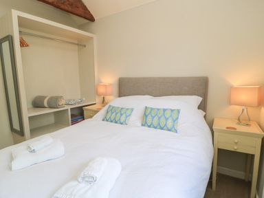 A bedroom with a double bed and bedside table at The Cider Press, Motcombe