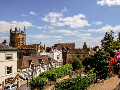 A town view with historical buildings church tower and greenery under a blue sky at The Packing House in Hanley Castle near Malvern