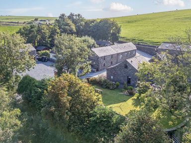 An outdoor view of buildings and trees at Elm Lodge in Ulverston