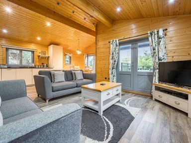 A living room with a sofa and coffee table at Elm Lodge in Ulverston