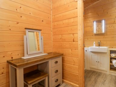 A bathroom with a mirror and sink at Elm Lodge in Ulverston