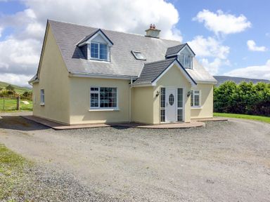 A detached house with two dormer windows and a gravel driveway at The Slate House in Cahersiveen County Kerry