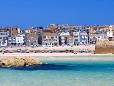 A coastal town with a beach boats and stone buildings near the water at Cot Valley Cottage in St Just