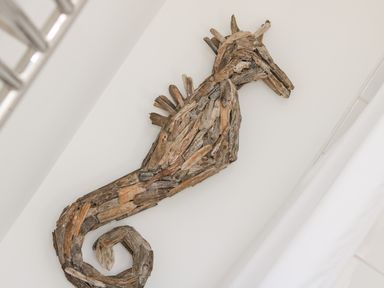 A wall decoration of a seahorse made from driftwood at Sea Breeze in Marazion