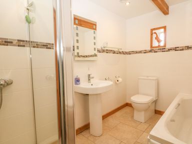 A bathroom with a shower, sink, toilet, and bathtub at Back Of Beyond in St Ives