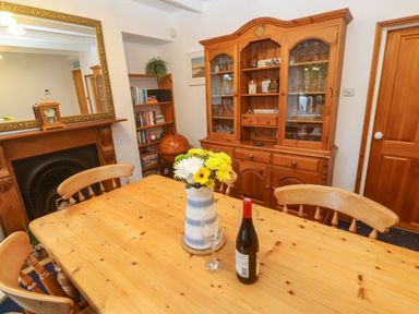 A dining room with a table and chairs at Angarrack Farmhouse in Hayle