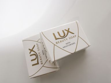 Two bars of Lux beauty soap with moisturisers in white packaging on a surface