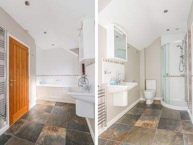 A bathroom with a bathtub sink toilet and glass shower enclosure at Carne Mill in Manaccan