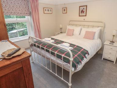 A bedroom with a bed and side tables at Banneth in Helford