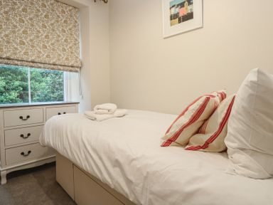 A bedroom with a bed and a window at Banneth in Helford