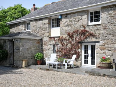 An outdoor area with chairs and planters at Trevenning Barn near Port Isaac
