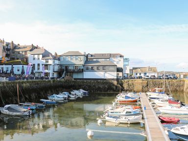 A small harbor with moored boats and buildings along the waterfront at Seabien in Falmouth