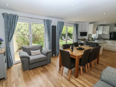 A dining room with a table and chairs at Glebe House in Bigbury