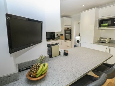 A kitchen with a countertop and kitchen appliances at Glebe House in Bigbury