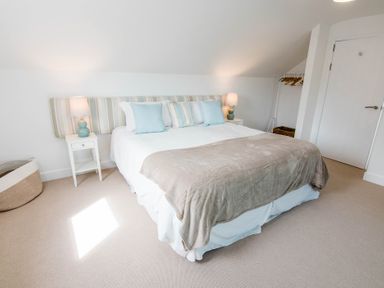A bedroom with a bed and nightstand at Lanesend in St Agnes