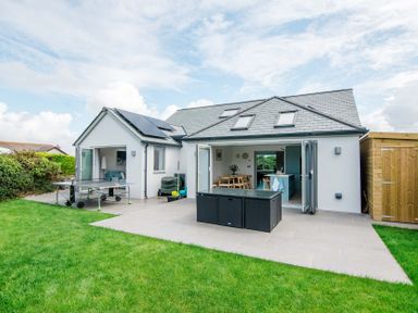 A house with sliding doors and garden furniture at Lanesend St Agnes