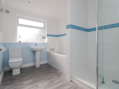 A bathroom with a toilet sink bathtub and shower at St Ives View in Porthtowan