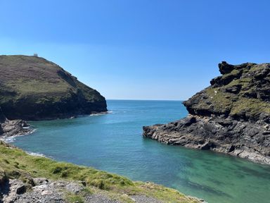 A coastal scene with cliffs and clear water at Oaklands Near Boscastle
