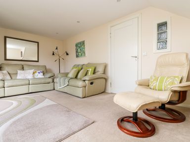 A living room with two sofas and a recliner chair with footrest at Riverview in Lostwithiel