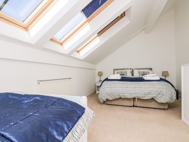 A bedroom with two beds and skylight windows at Riverview in Lostwithiel