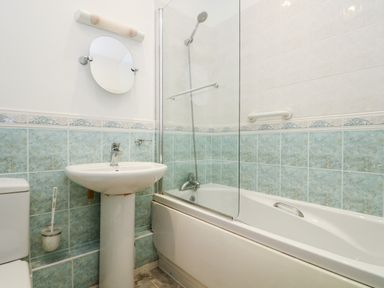 A bathroom with a pedestal sink toilet bathtub and shower at Riverview in Lostwithiel