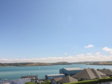 A coastal view with houses and a marina with boats on water at Tides in Padstow
