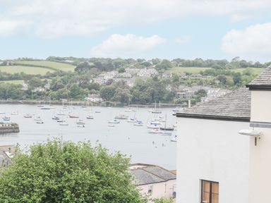 A coastal view with boats on water and houses on a hillside at Lookout in Falmouth