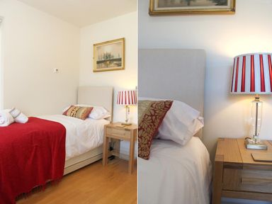 A bedroom with a single bed white bedding red blanket and wooden nightstand with lamp at Totherside in Kingswear