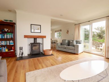 A living room with a fireplace and sofa at Seaport Lodge in Mawgan Porth
