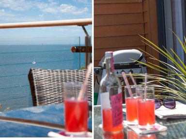 A balcony with drinks on a glass table a barbecue and a view of the sea at Bayview in Brixham