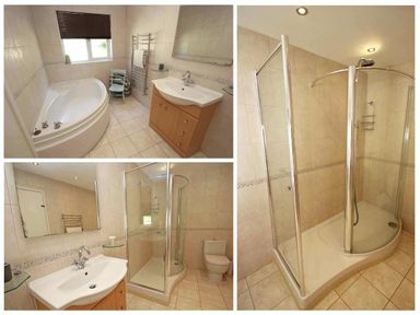 A bathroom with a corner bathtub a wooden vanity with sink a glass shower enclosure and a toilet at Windrush in Mawgan Porth