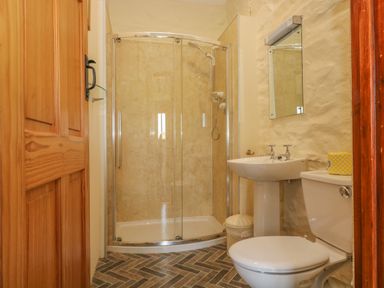 A bathroom with a shower enclosure toilet and sink at Marhayes in Camelford