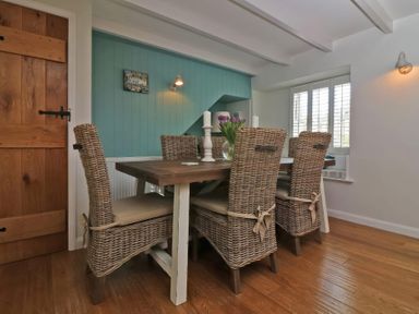 A dining room with a table and chairs at Trelan in Mevagissey
