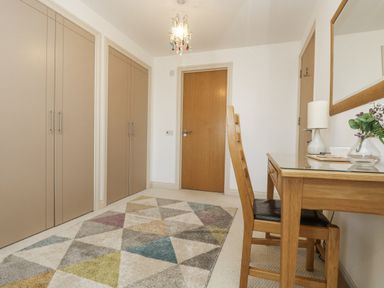 A hallway with a desk and chair at Ridgeback House in Mullion