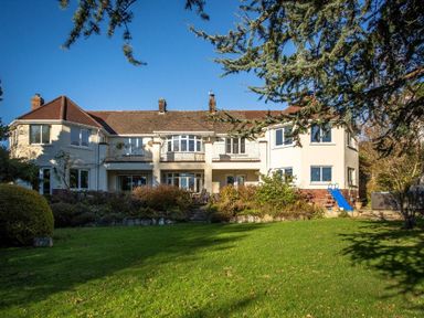 A large house with a garden and a blue slide at Nairn in Braunton