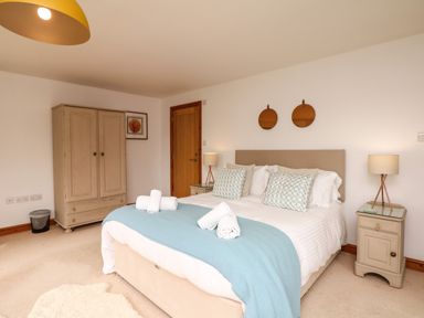 A bedroom with a double bed and side tables at Nairn in Braunton