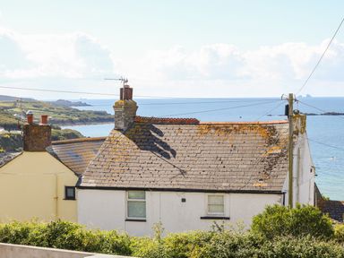 A house with a tiled roof near the coast with the sea and sky in the background at Hagar Vor in Marazion