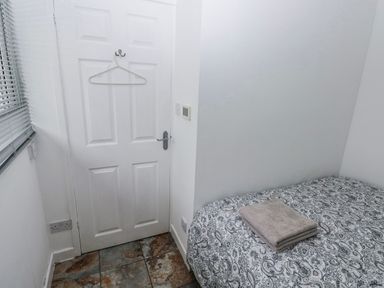 A bedroom with a bed and towel at Trelessy Lodge Llanteg near Amroth