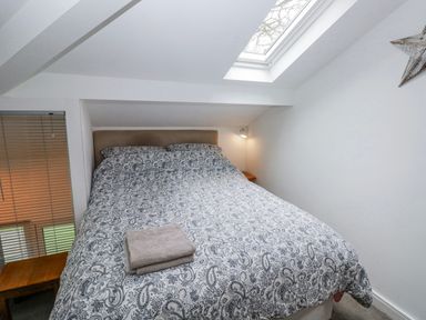 A bedroom with a bed and bedside table at Trelessy Lodge Llanteg near Amroth