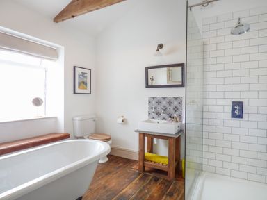 A bathroom with a bathtub toilet sink and shower at Star House in Marazion
