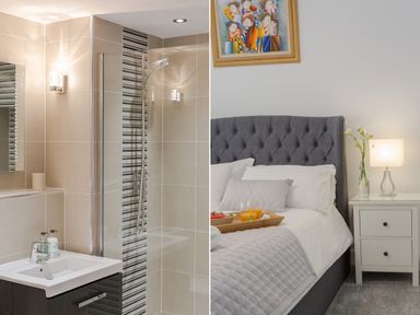 A bathroom with a sink and shower next to a bedroom with a grey bed and nightstand at No 6 Arlington Villas Ilfracombe