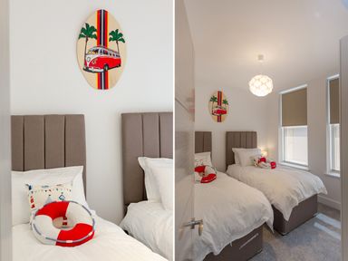 A bedroom with two single beds with brown headboards and white bedding with life preserver cushions on each bed and a wall decoration of a red van and palm trees at No 6 Arlington Villas in Ilfracombe