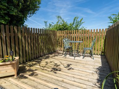 An outdoor area with a table and chairs at Easterly Cottage in Bude
