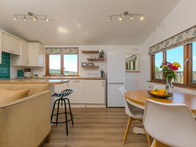 A kitchen with a table and chairs at Costentyn, Tor Down Quarry St Breward