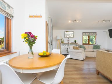 A dining area with a table and chairs at Costentyn, Tor Down Quarry St Breward